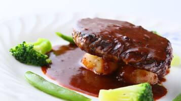 A plate with a meat dish, vegetables, and sauce.