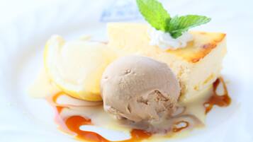 A dessert with ice cream and caramel sauce on a white plate.
