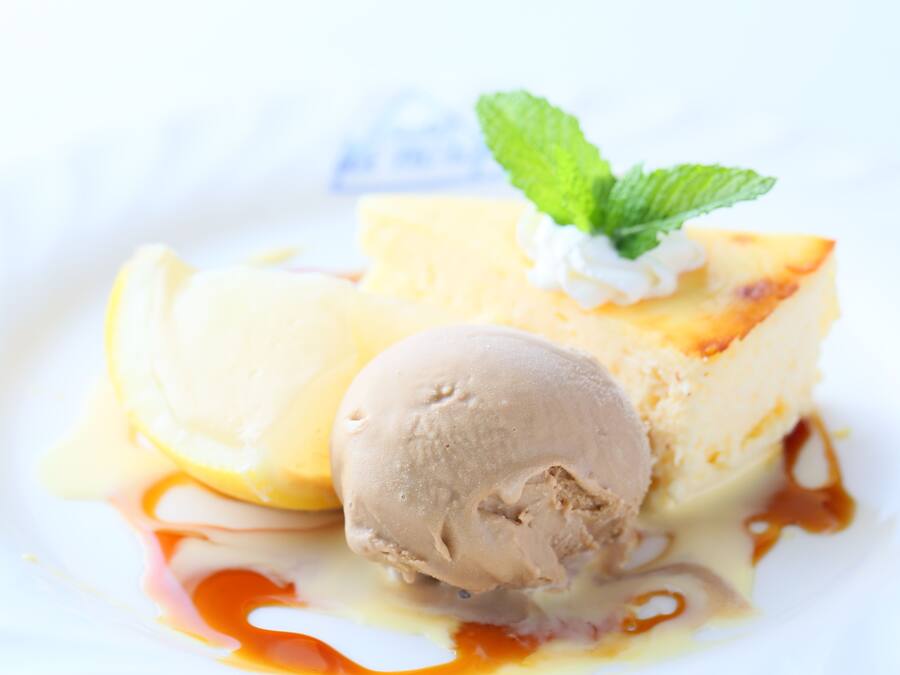 A dessert with ice cream and caramel sauce on a white plate.