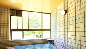 A spa room with a tiled wall, a window, and a hot tub. - Chalet La Neige (Minakami)