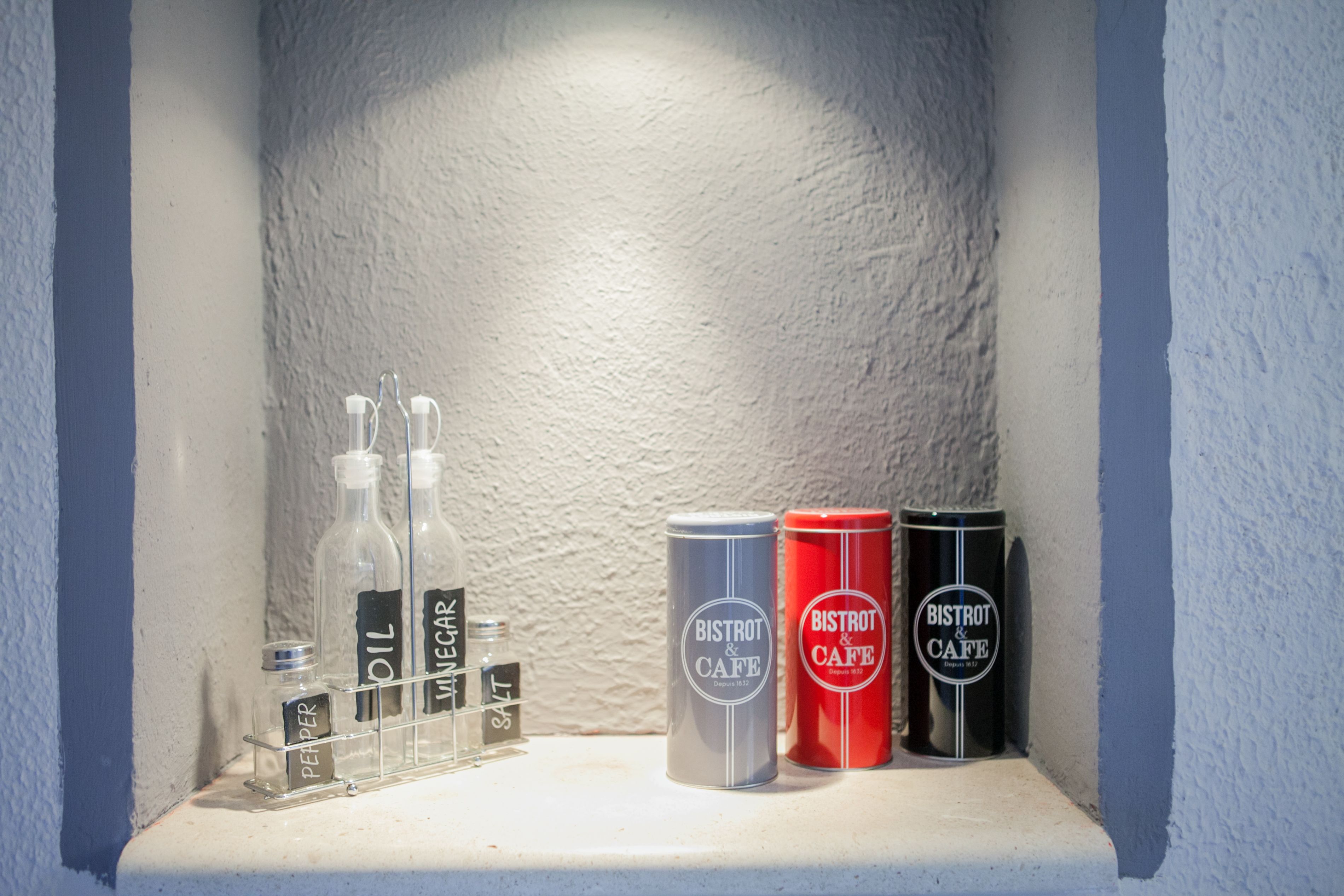 A shelf with bottles and cans labeled 'BISTROT & CAFE'.