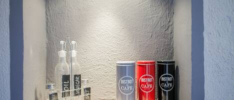 A shelf with bottles and cans labeled 'BISTROT & CAFE'.