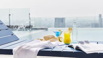 Outdoor pool, open 6 AM to 10 PM, pool loungers