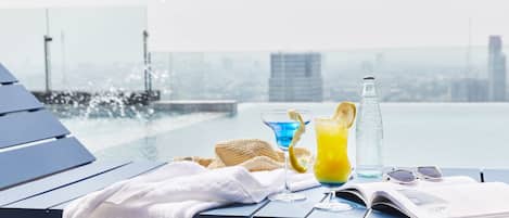 Outdoor pool, open 6 AM to 10 PM, pool loungers