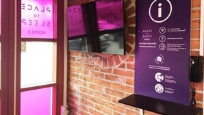 A hotel entrance with a purple sign indicating the place to sleep and a digital display with the hotel's name. - Place to Sleep Hotel Rauma (Rauma)