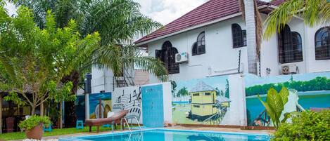 Outdoor pool, pool loungers, lifeguards on site