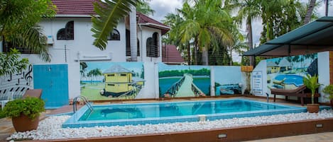 Outdoor pool, pool loungers, lifeguards on site