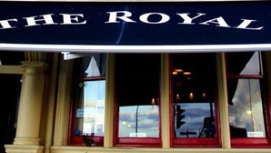 A building with a sign reading "THE ROYAL BAR" at the ground level. - The Royal (Morecambe)
