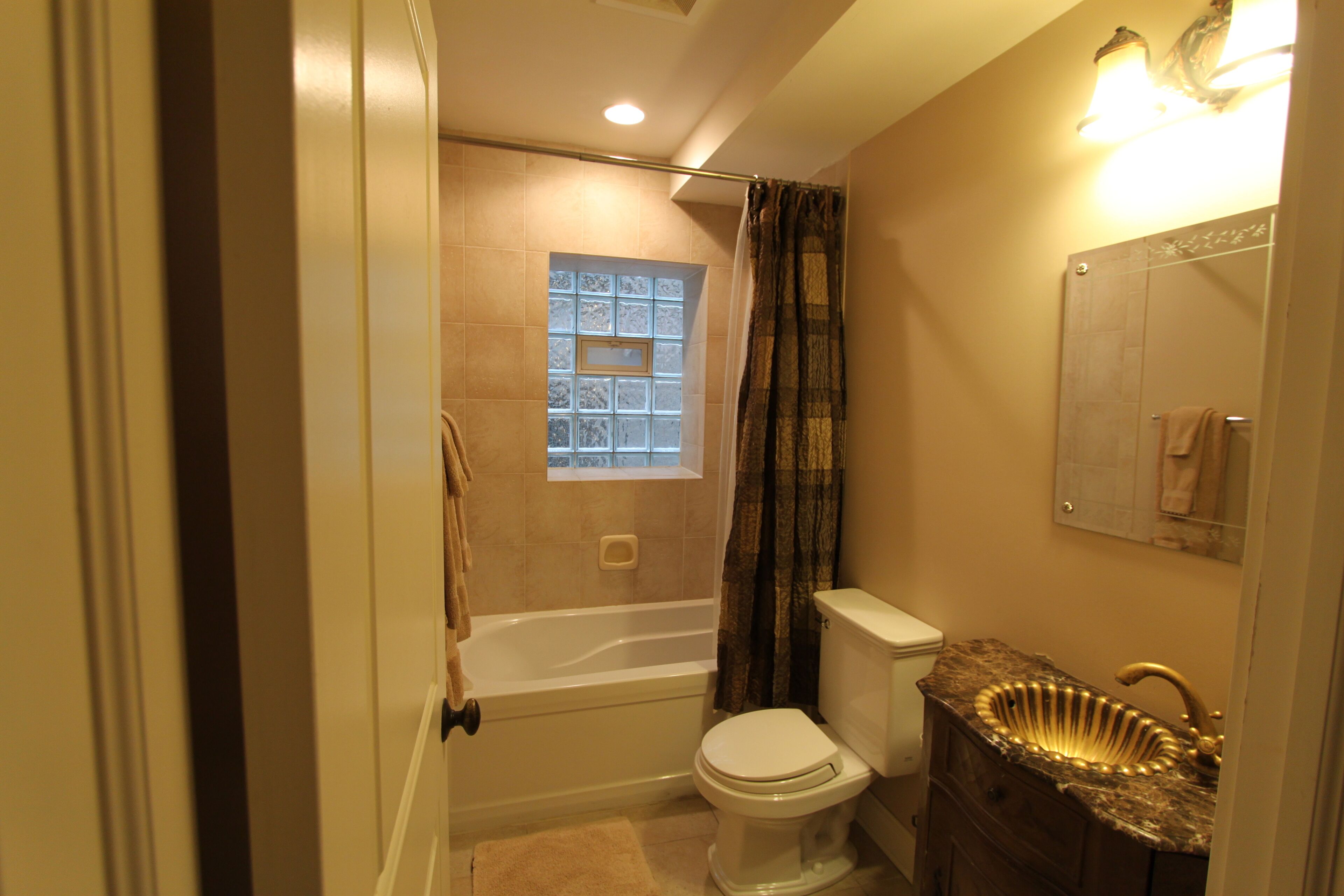 A bathroom with a bathtub, toilet, and sink.