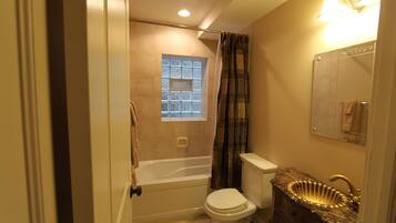A bathroom with a bathtub, toilet, and sink.