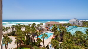 A resort with a pool, beach, and ocean view. - Updated Beachfront Condo - Beach View, Balcony, Pool, Tiki Bar, Hot Tub, Tram (Miramar Beach)