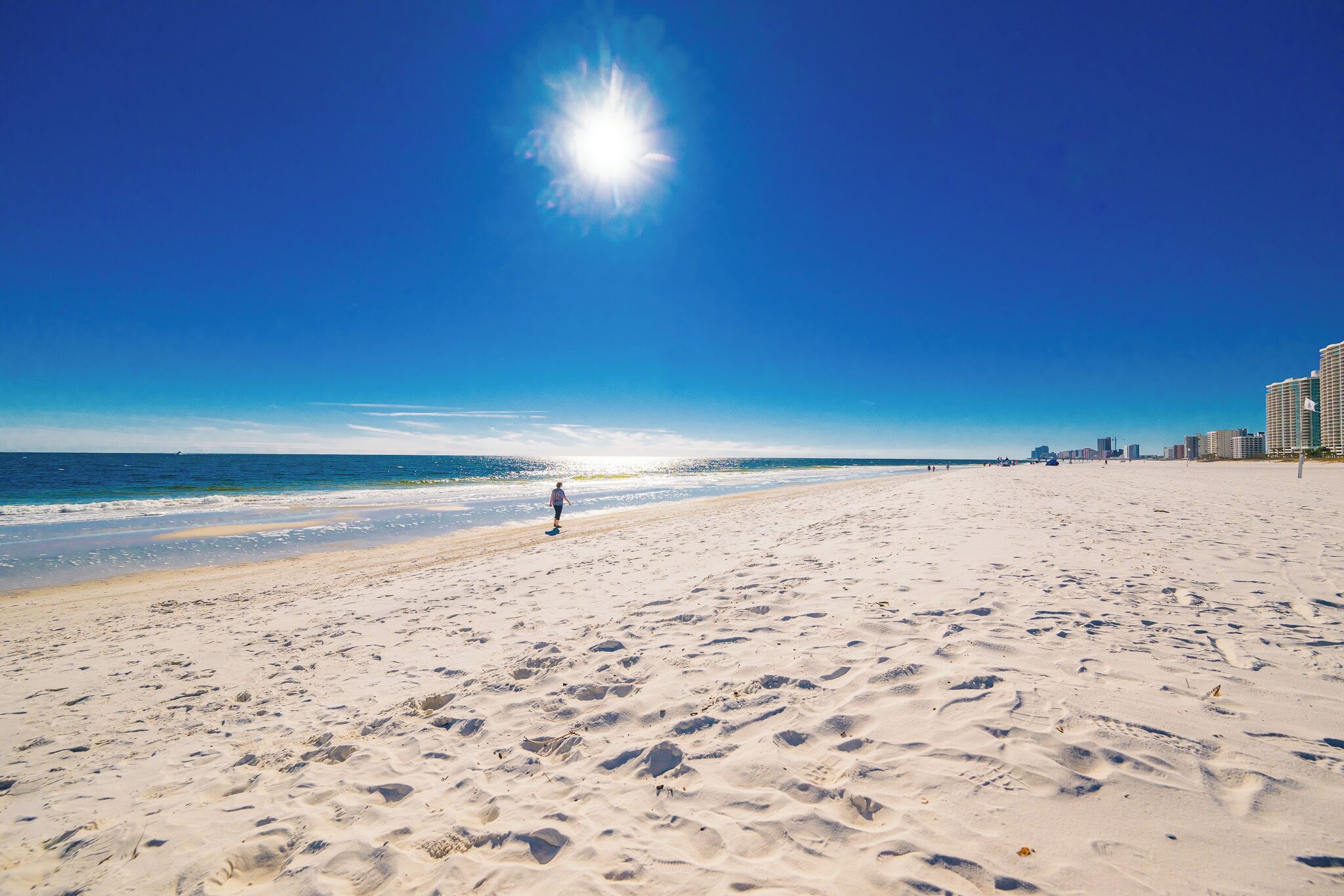 Experience serene beach walks along pristine white sands with breathtaking views and a peaceful atmosphere at Phoenix VII