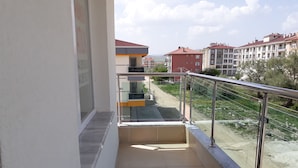 A balcony with a metal railing, a view of a residential area, and a sign for a hotel. - Dr.Aslan Apart Hotel - Airport (Cubuk)