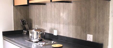 A kitchen with a microwave, a stove, and a sink.