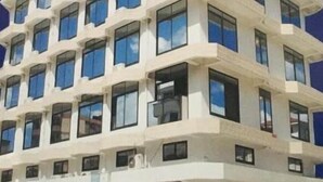 A multi-story building with a modern architectural design, featuring a series of balconies and large windows. - Florida Executive Inn (Dar es Salaam)