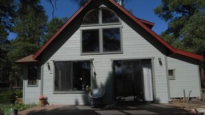 A two-story house with a gabled roof, large windows, and a covered patio area. - Sweet Getaway House Close to all the best Arizona has to offer (Parks)
