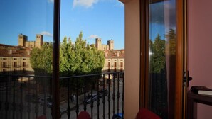 A balcony with a view of historic buildings and trees. - Hotel HC Sigüenza (Siguenza)