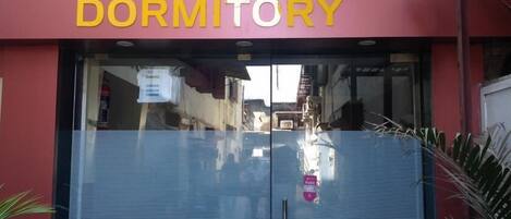 A dormitory building with a large sign reading "ZARA DORMITORY".