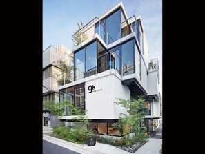 Un edificio moderno con ampie vetrate e un'insegna con la scritta "9h nine hours".