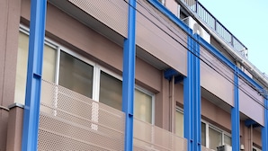 A building with a sign reading "Rooms is so welcome" and a sign for "SAKE". - Rooms (Tokyo)