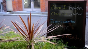 A signboard with check-in and check-out times, weather information, and a message for a nice day. - Rooms (Tokyo)
