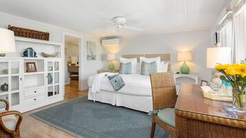 A bedroom with a bed, bedside tables, a chair, a desk, and a bookshelf.