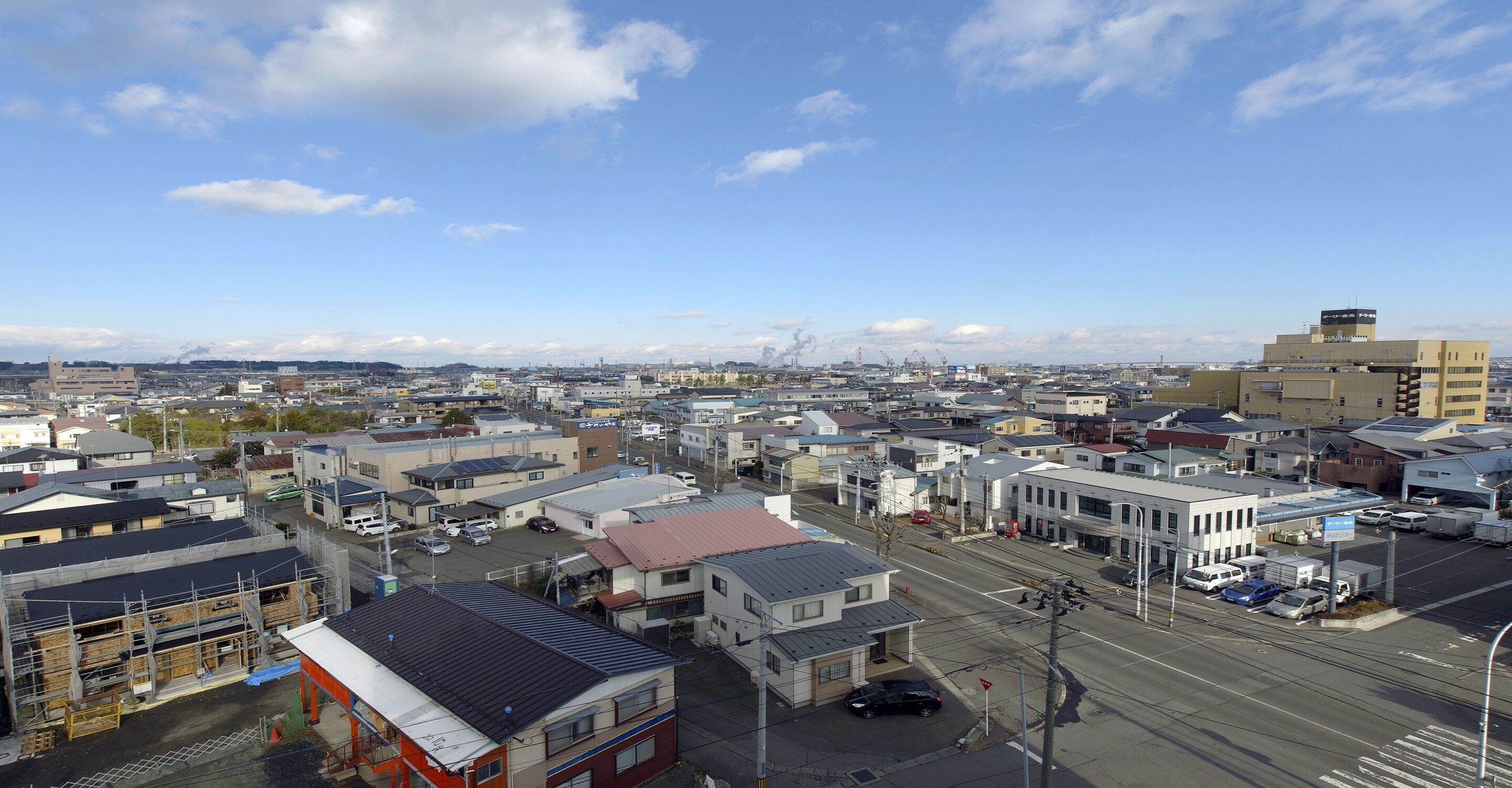 A cityscape with various buildings, streets, and vehicles.