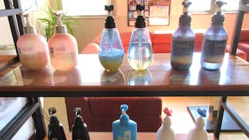 A table with various bottles of liquid soap and lotion.