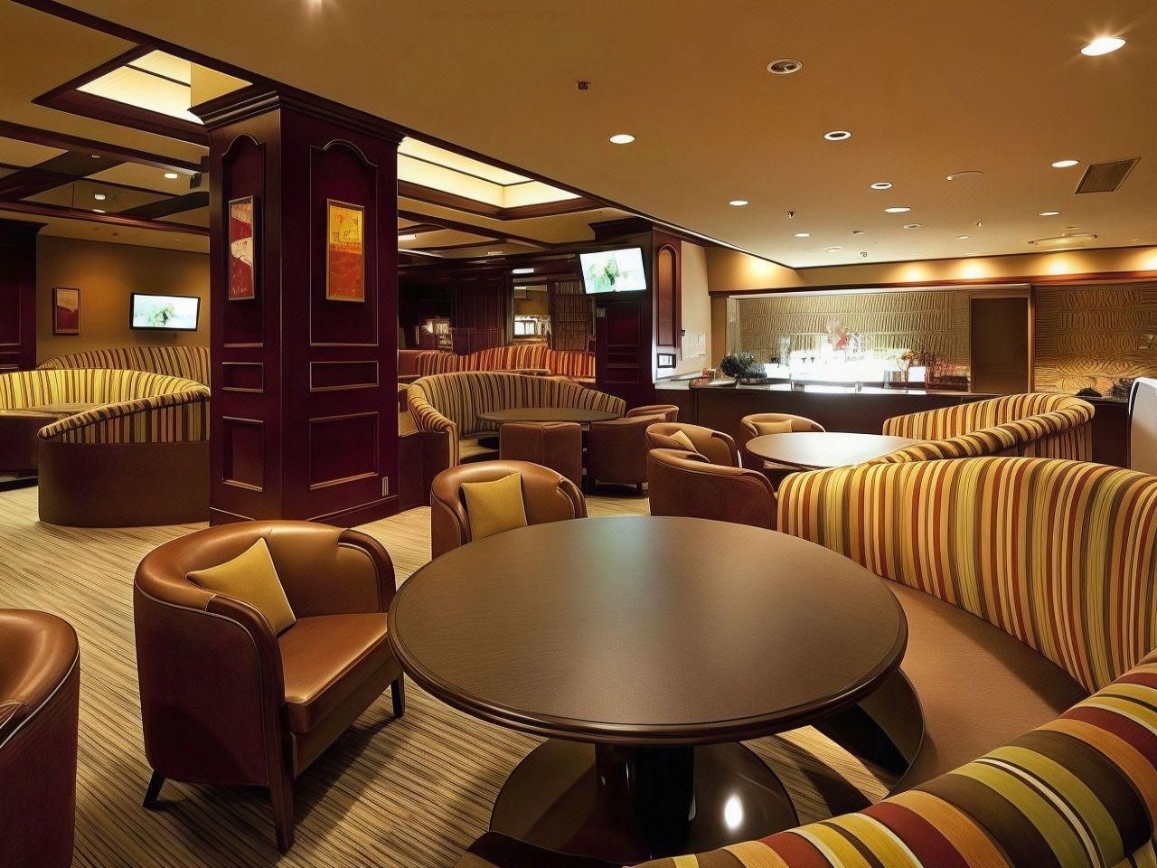 A hotel lobby with seating areas, a bar, and a television screen.
