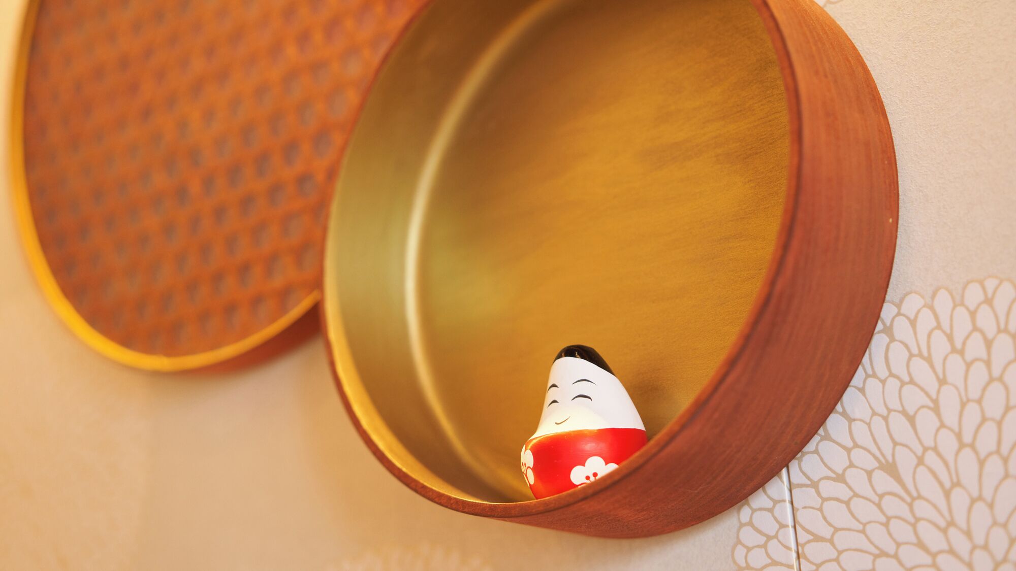 A wooden bowl with a smiling figure inside.