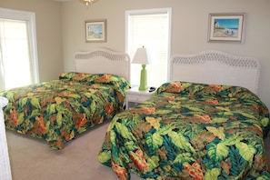 A bedroom with two beds, a nightstand, a lamp, and two framed pictures on the wall. - Bermuda Breeze C Holiday Home Holiday home 8 (North Myrtle Beach)