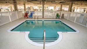 A rectangular pool with a 3-foot depth marker, surrounded by a white fence and various chairs. - Coconut Grove 204 Villa Villa 5 (North Myrtle Beach)