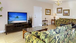 A living room with a television, sofa, and coffee table. - Coconut Grove 402 Villa Villa 6 (North Myrtle Beach)