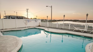 A swimming pool with a white fence and a view of the water. - Grand Cayman C Holiday Home Holiday home 8 (North Myrtle Beach)