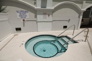 A small indoor pool with a lifeguard sign and a warning sign. - Myrtle Beach 303B Villa Villa 6 (Myrtle Beach)