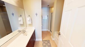 A modern bathroom with a double sink, a large mirror, and a shower area. - Myrtle Beach 305A Villa Villa 4 (Myrtle Beach)