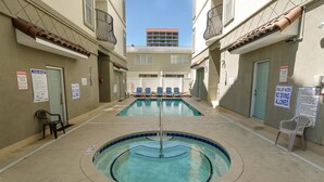 A pool area with two pools, lounge chairs, and safety signs. - Tuscan Ocean Vista B Holiday Home Holiday home 8 (Myrtle Beach)