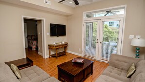 A living room with two sofas, a coffee table, a TV, and a ceiling fan. - Tuscan Ocean Vista B Holiday Home Holiday home 8 (Myrtle Beach)