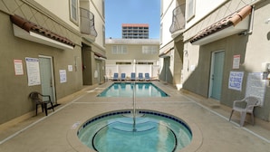 A pool area with two pools, lounge chairs, and safety signs. - Tuscan Ocean Vista D Holiday Home Holiday home 8 (Myrtle Beach)