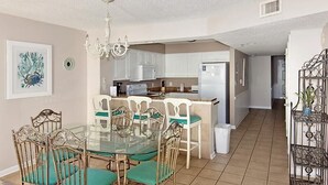 A compact kitchen with white cabinets, a refrigerator, and a microwave. - Crescent Shores N - 703 Apartment 4 (North Myrtle Beach)
