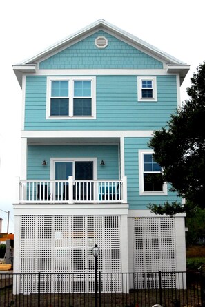 A two-story house with a balcony and a white fence. - South Beach Cottages - 2706 Apartment 4 (Myrtle Beach)