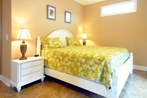 A bedroom with a bed, two bedside tables, and two lamps. - South Beach Cottages - 2706 Apartment 4 (Myrtle Beach)
