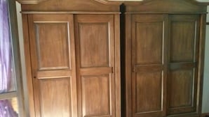 A room with a large wooden wardrobe, a window with a view, and a door. - Aurelio Rapillo (Latina)