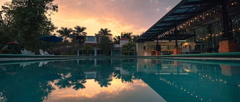 Una piscina al aire libre, tumbonas