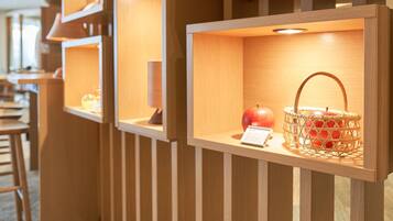 A series of wooden display cases with various items inside, including a basket and an apple.