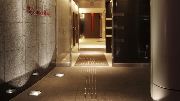 A modern hotel entrance with a sign reading "Richmond Hotel."