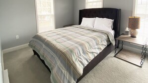 A bedroom with a bed, a ceiling fan, and two windows. - Roe Summer Cottage, Suite B (Watkins Glen)