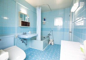 A bathroom with a bathtub, a sink, a toilet, and a shower.