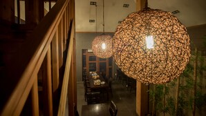 A staircase leading to a dining area with a long table set for a meal. - Club Castle (Hoengseong)