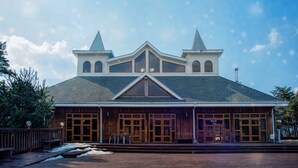 A large, two-story building with a steeply pitched roof, a central gable, and two symmetrical towers. - Club Castle (Hoengseong)